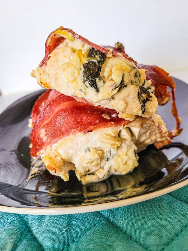 spinach artichoke stuffed chicken from side view. 