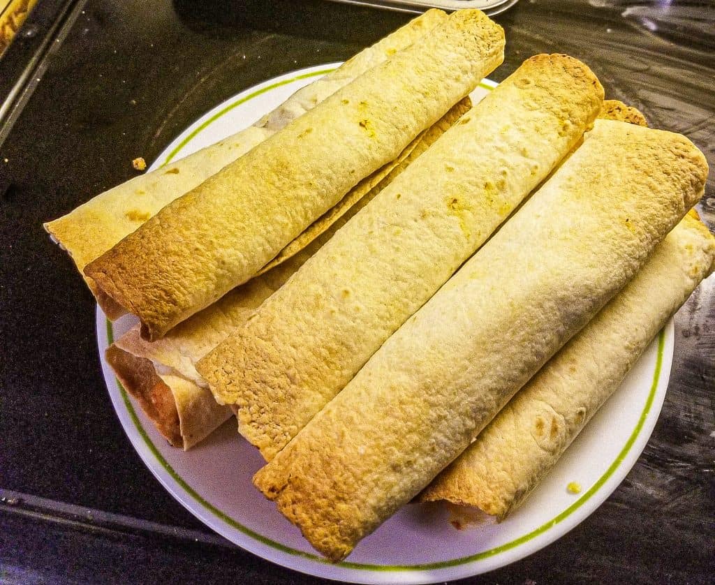 chicken flautas on a plate.