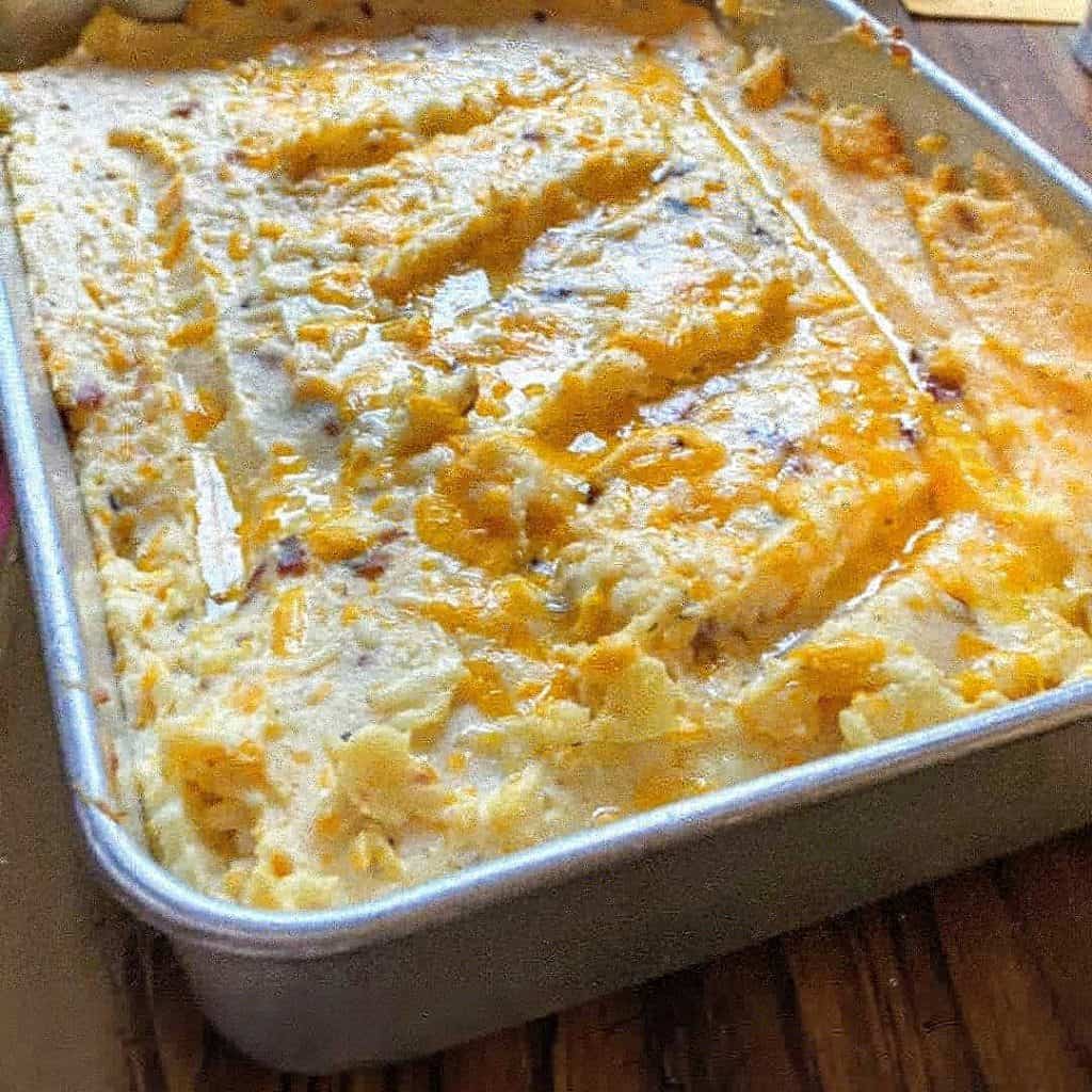 Loaded Mashed Potatoes in a pan on a table. 